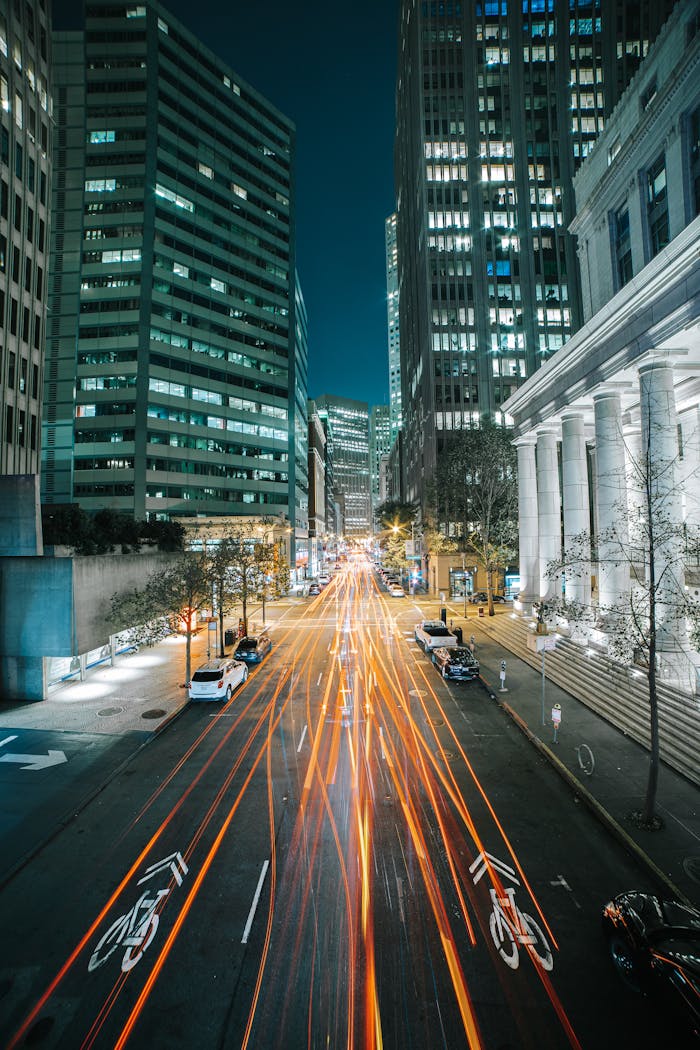 Dynamic night shot of San Francisco cityscape featuring light trails along urban streets.