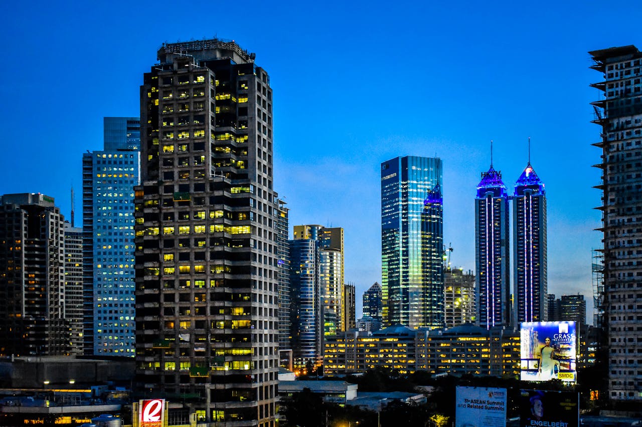 Illuminated skyscrapers at night in Pasig City, Philippines, showcasing modern architecture.